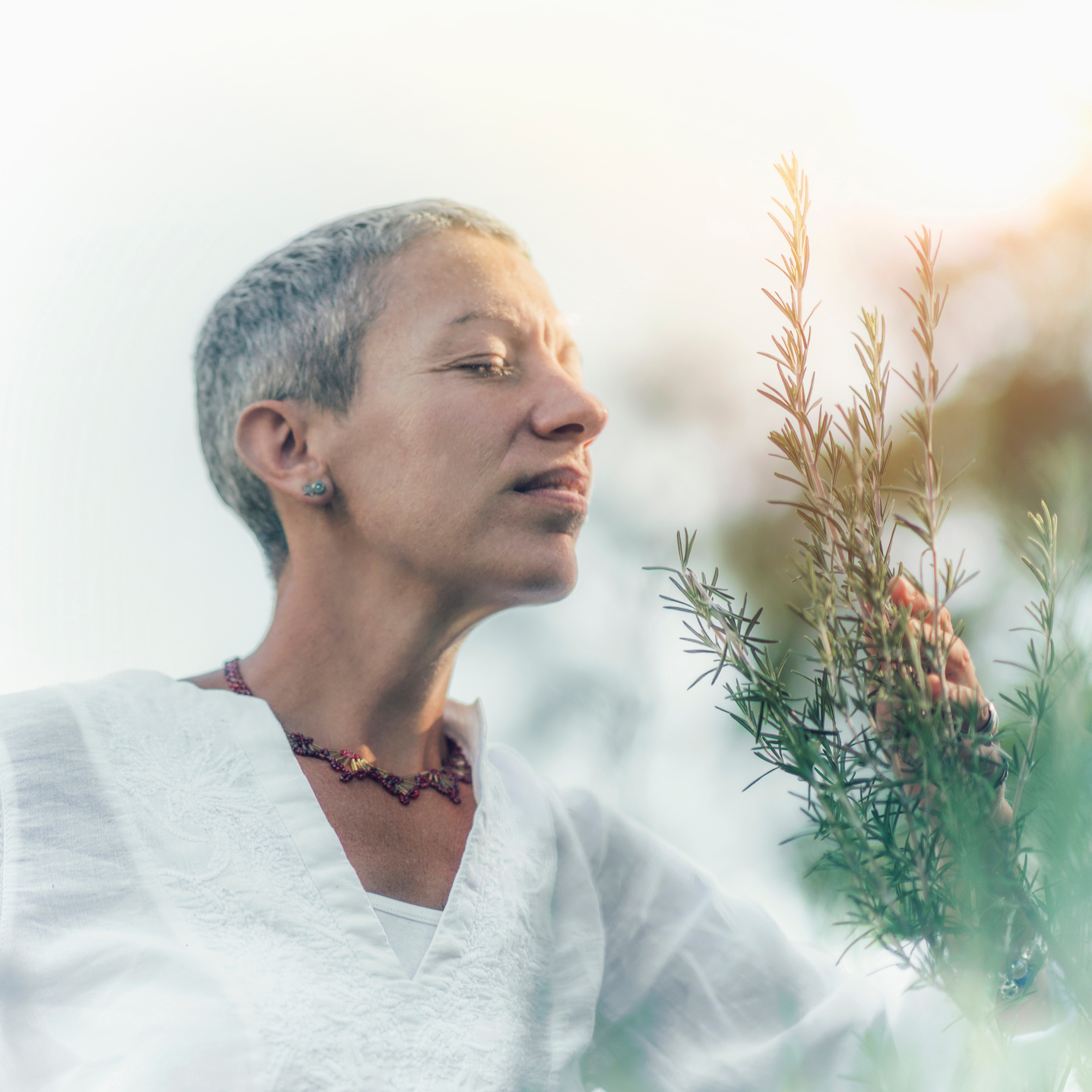 Abundance Concept. Mindful Woman Feeling Good, Enjoying the Scent of Rosemary