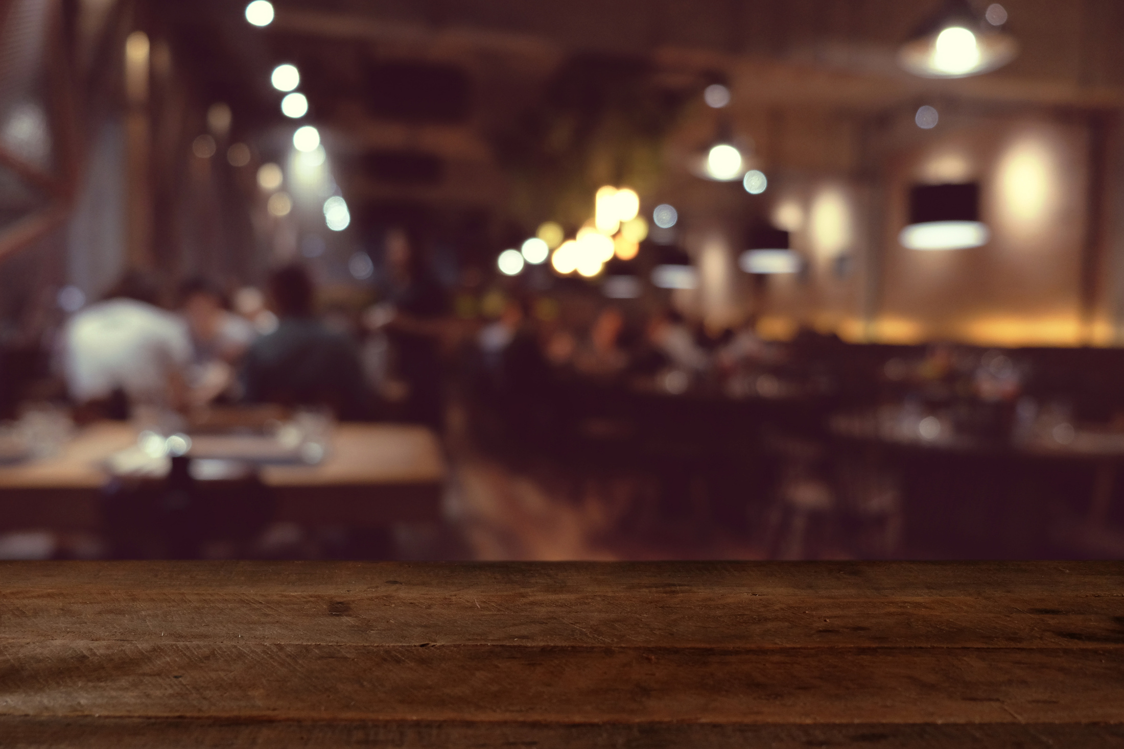 wood table on blur of cafe, coffee shop, bar, resturant, background - can used for display or montage your products