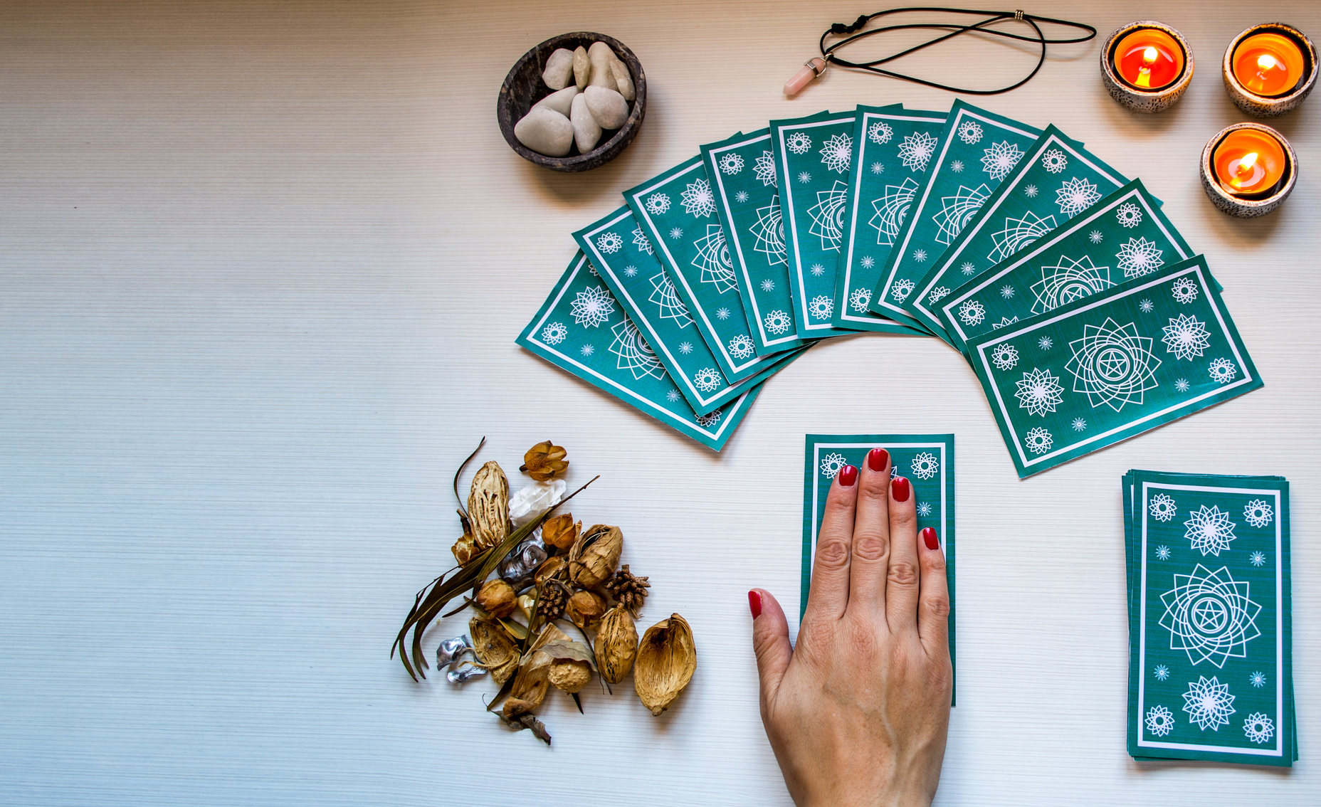 Fortune Teller with Green Tarot Cards and Candles