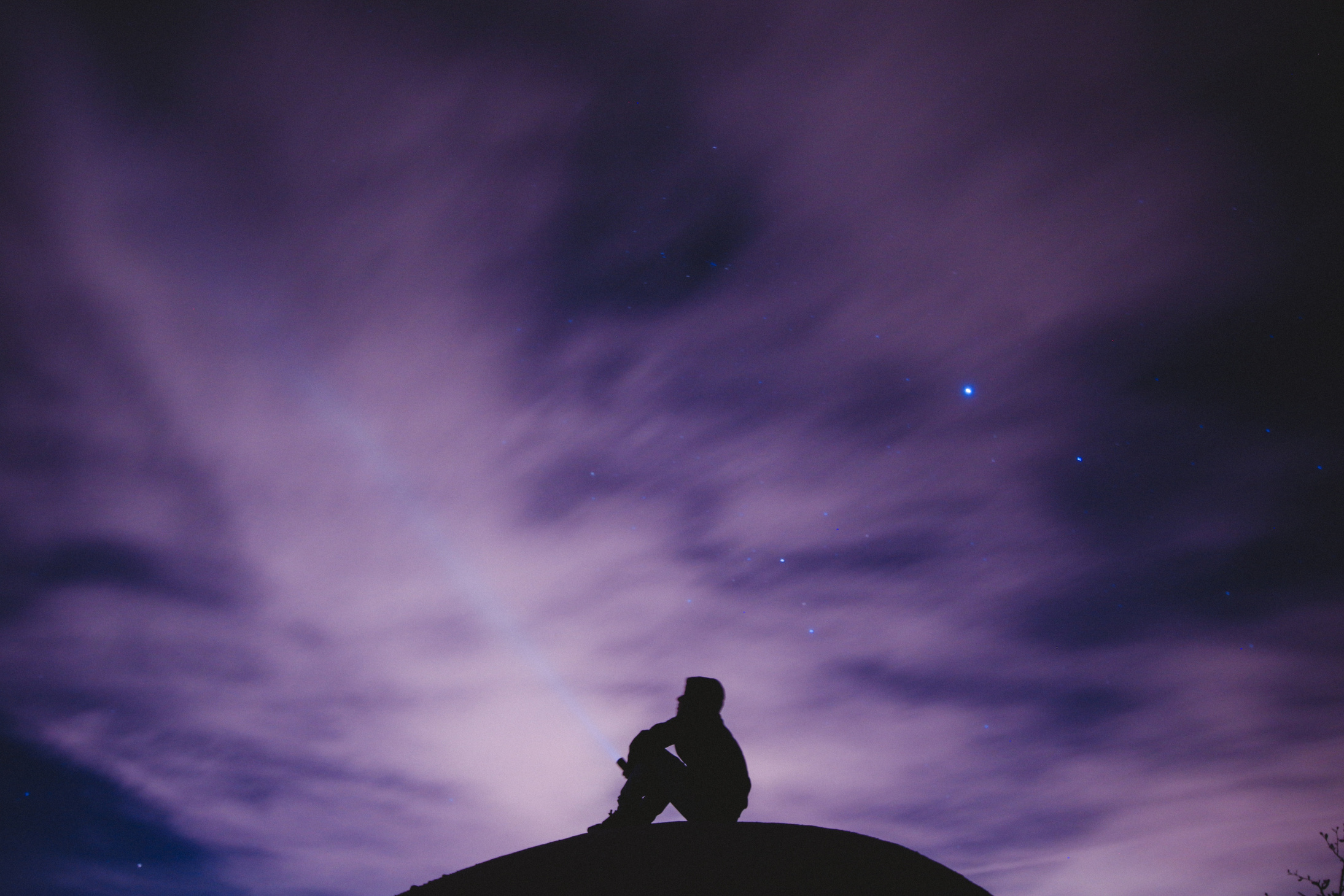 Man Along Thinking under Cloudy Night SKy