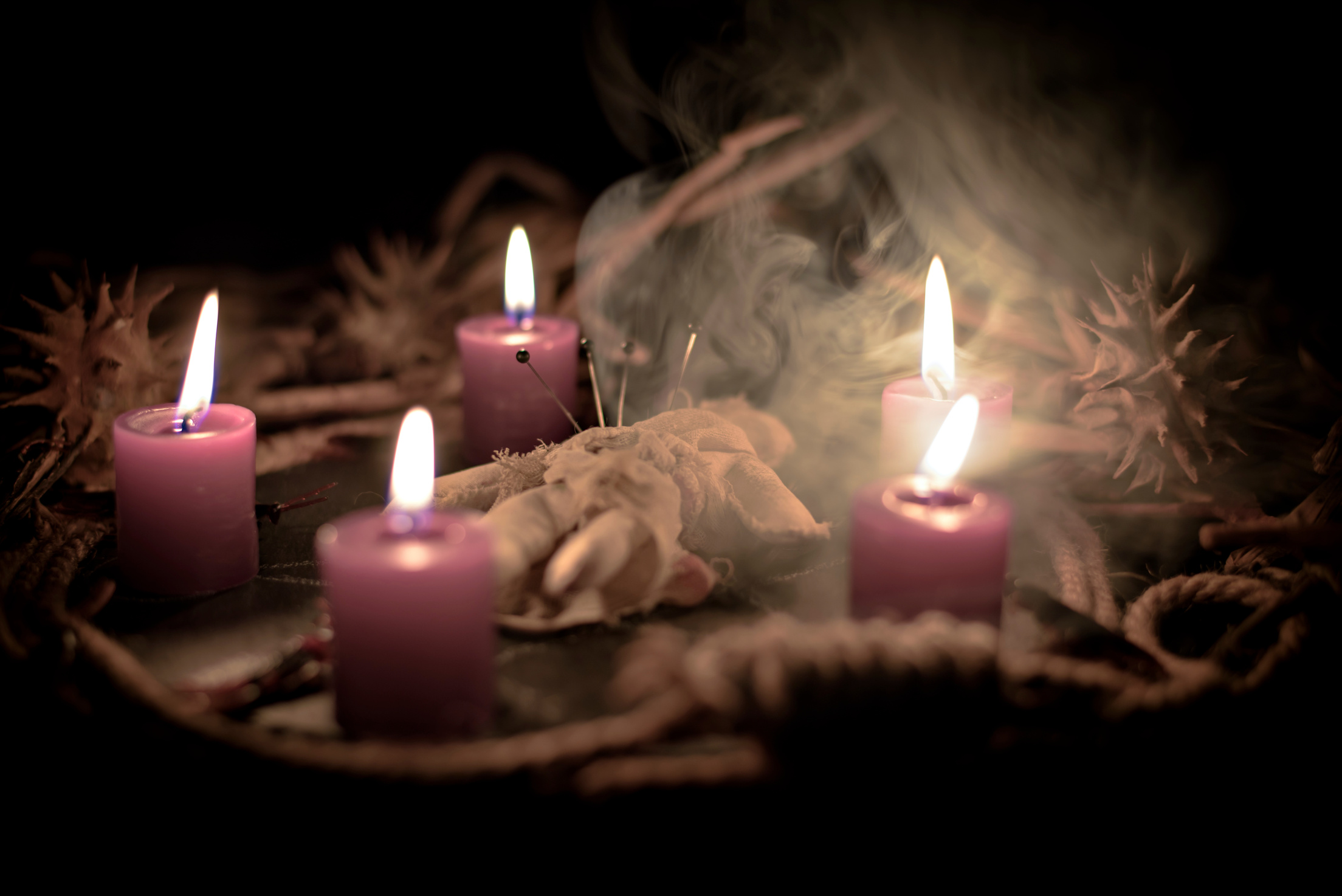 Pentagram amulet and black candle in autumn forest, natural background. Magic esoteric witches ritual. Mysticism, divination, wicca, occultism, witchcraft concept. Samhain sabbat.