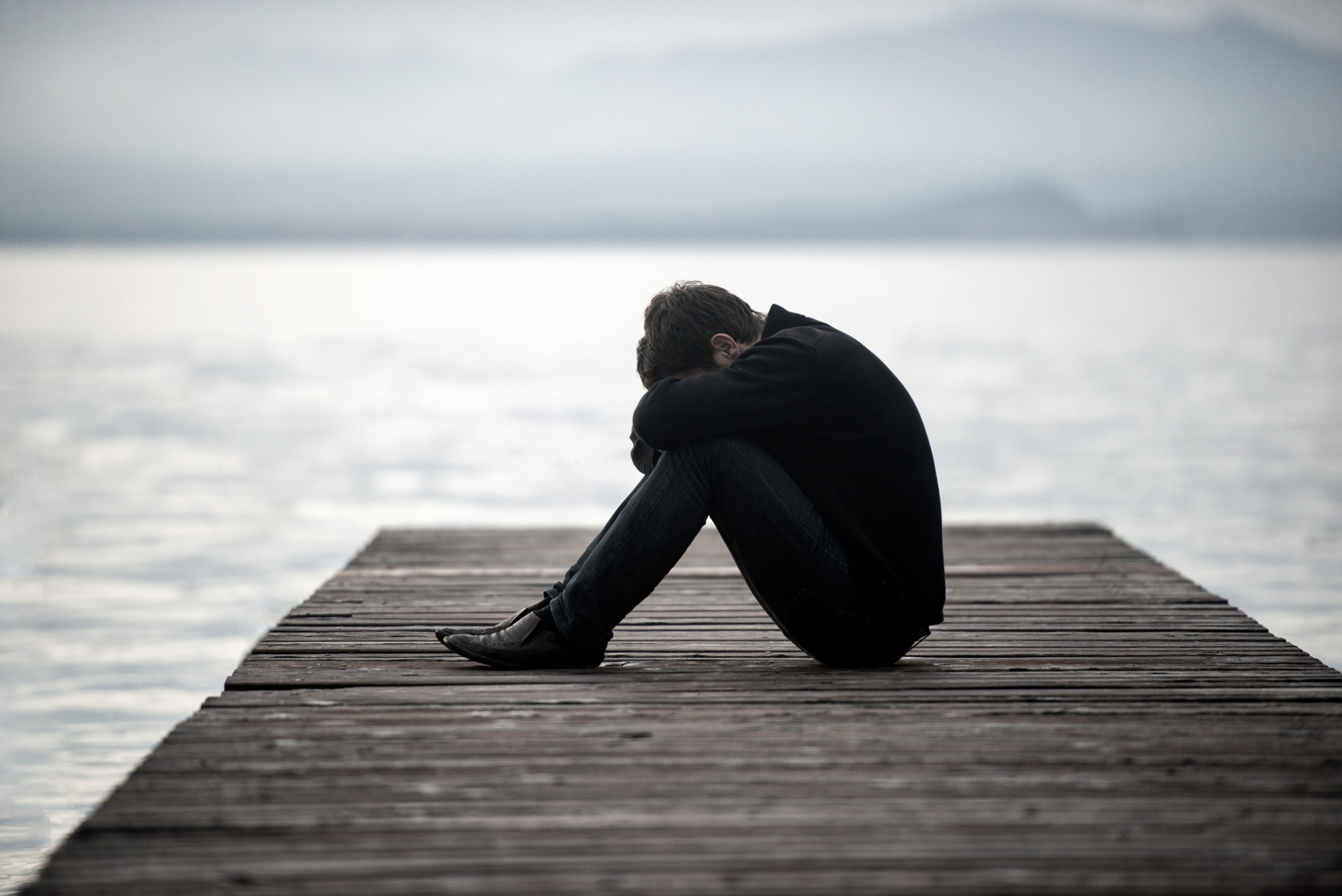 Sad Man on a Dock