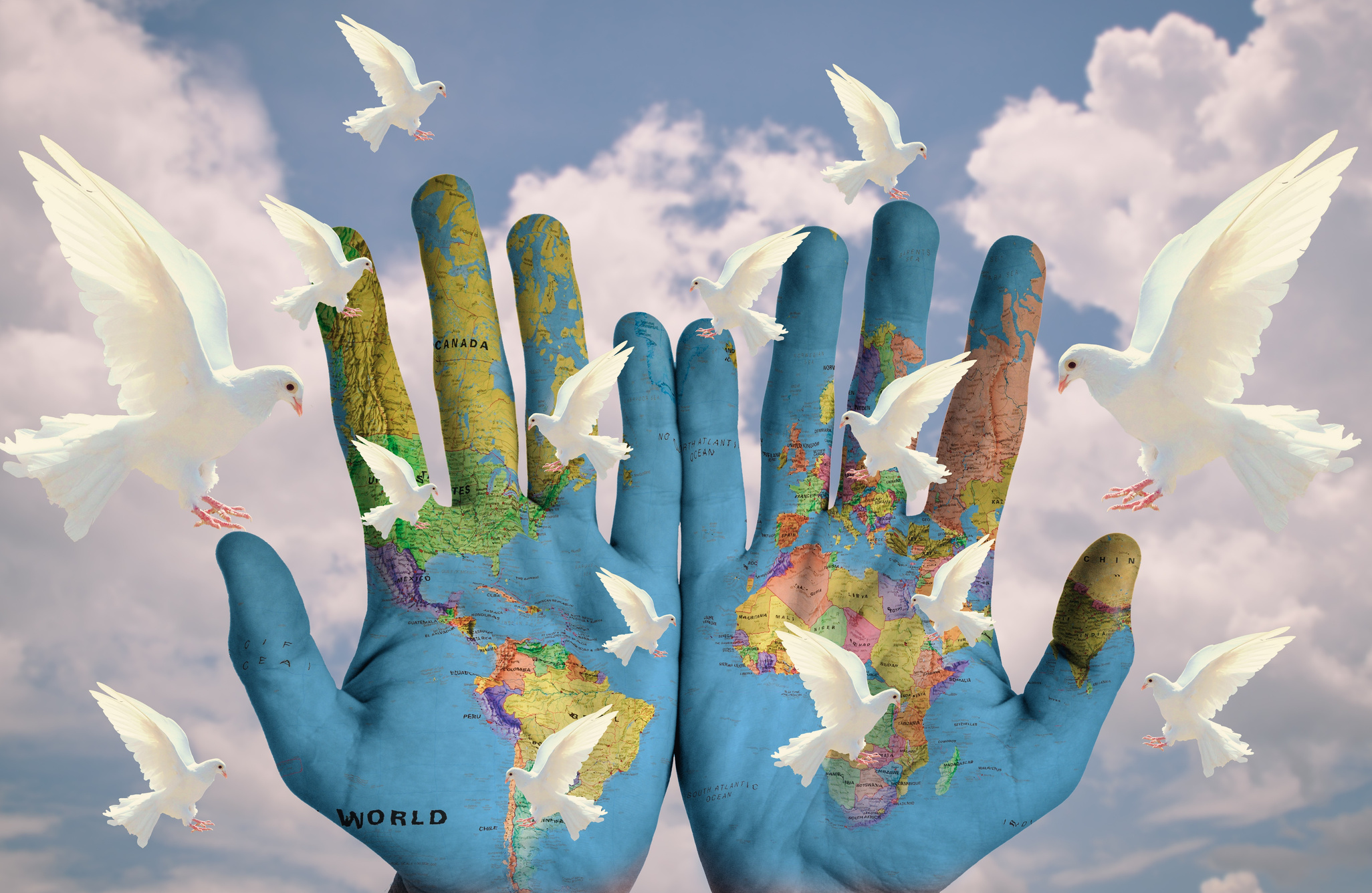 Photomontage Of Hands With World Map And Pigeons