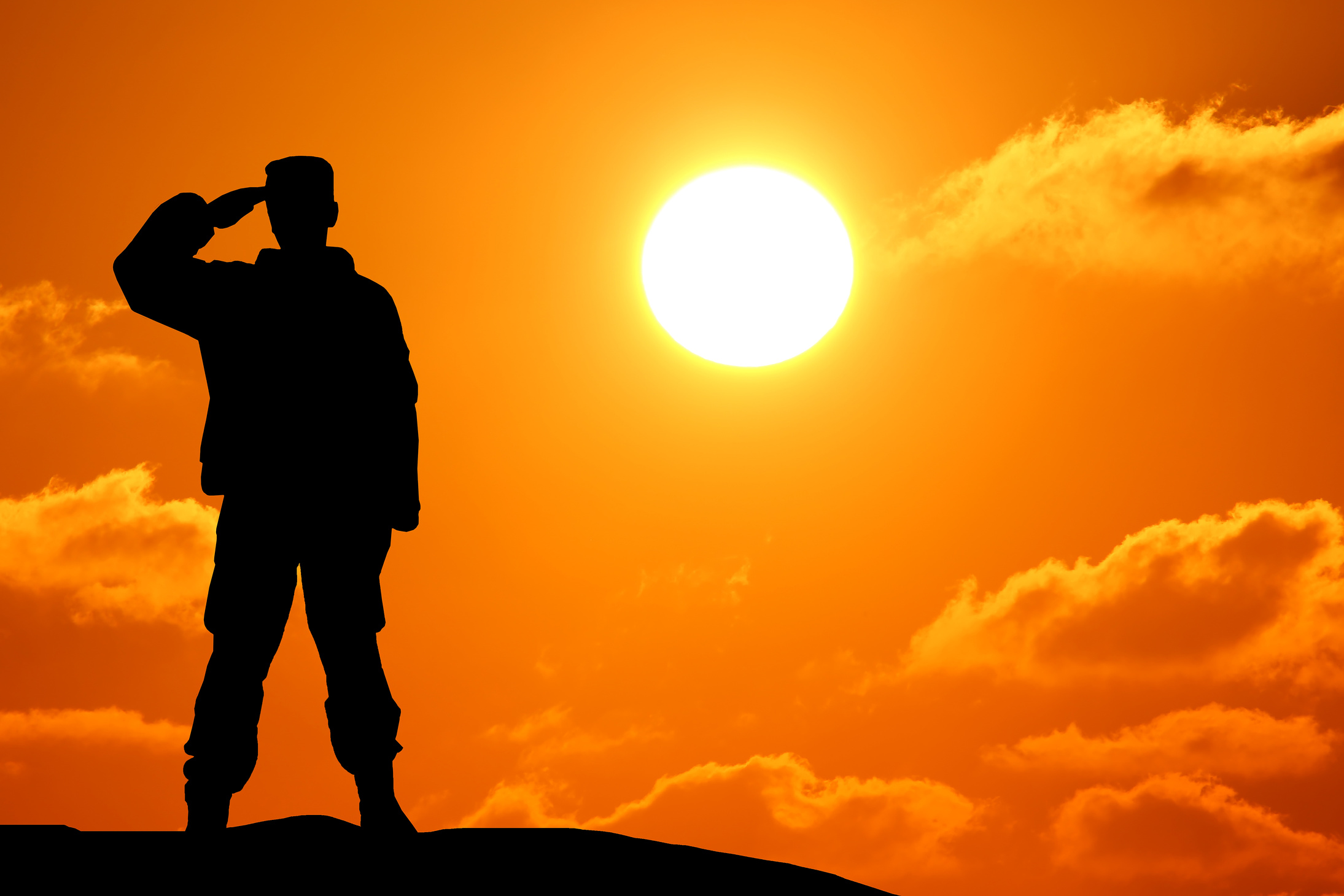 Silhouette Shot of Soldier Saluting with Colorful Sky in Background