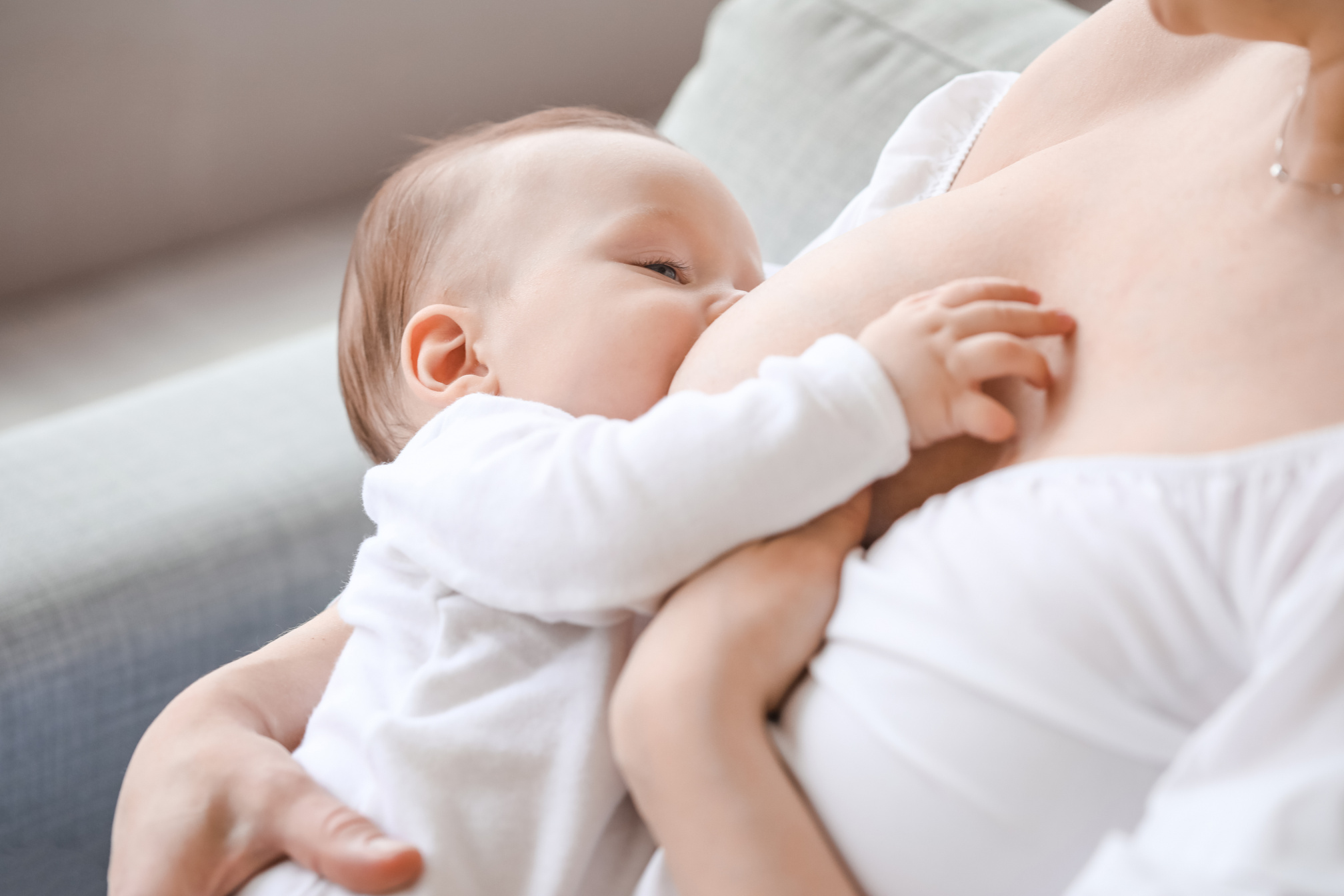 Young Woman Breastfeeding Her Baby at Home