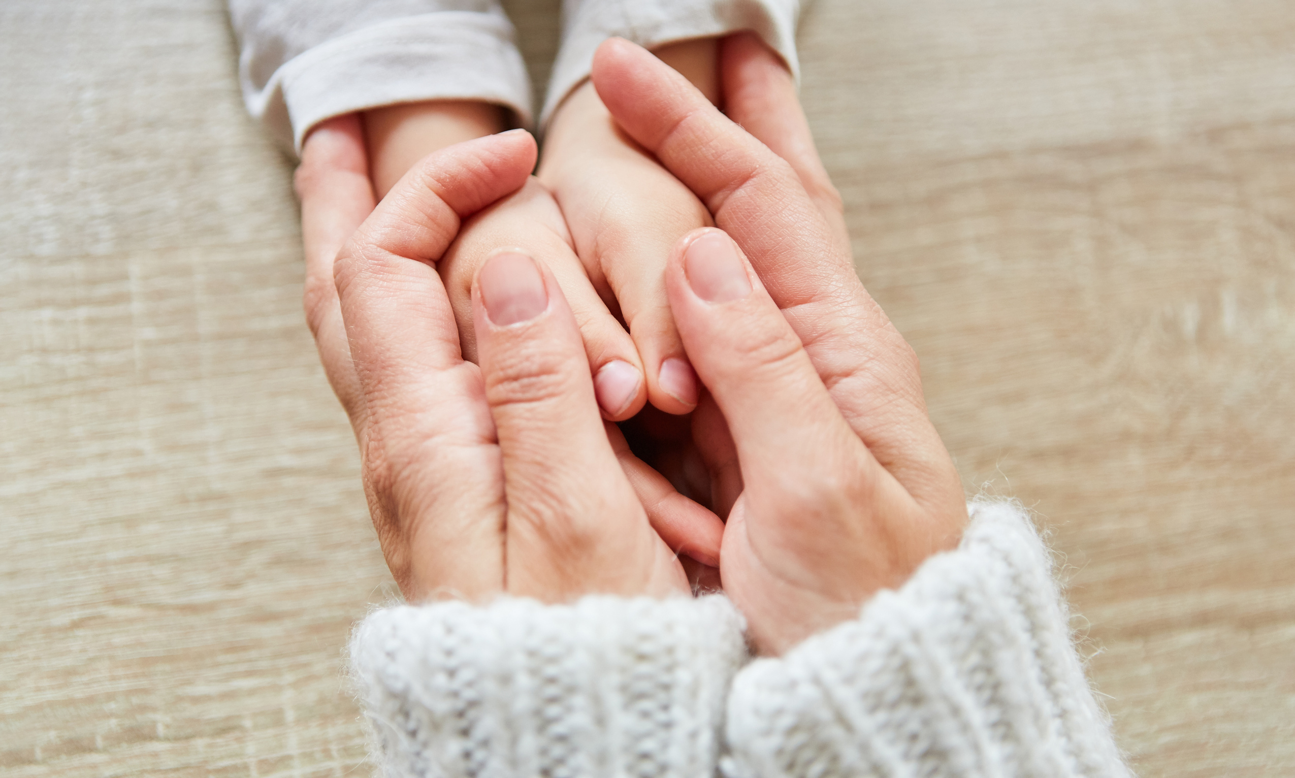 Mother Holding Her Child's Hands