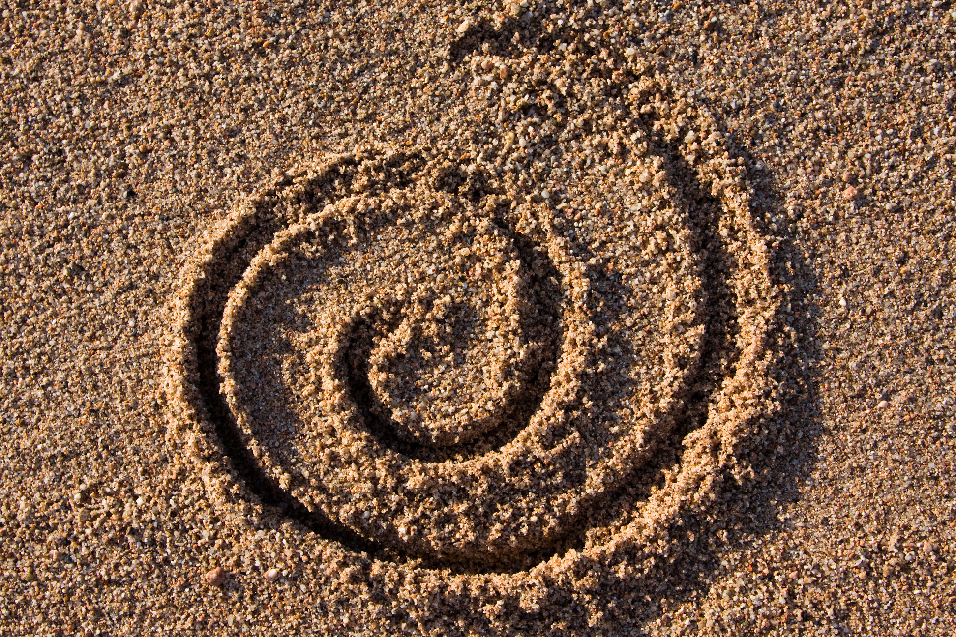 spiral sign in sand