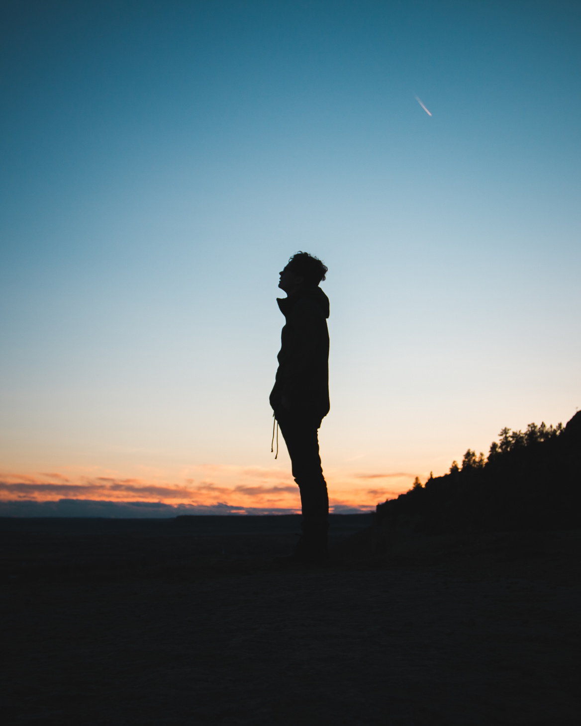 Silhoutte of a Man in a Mountain at Dusk